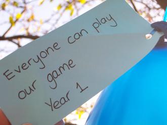 A pupil's work reading 'Everyone can play our game, year 1'