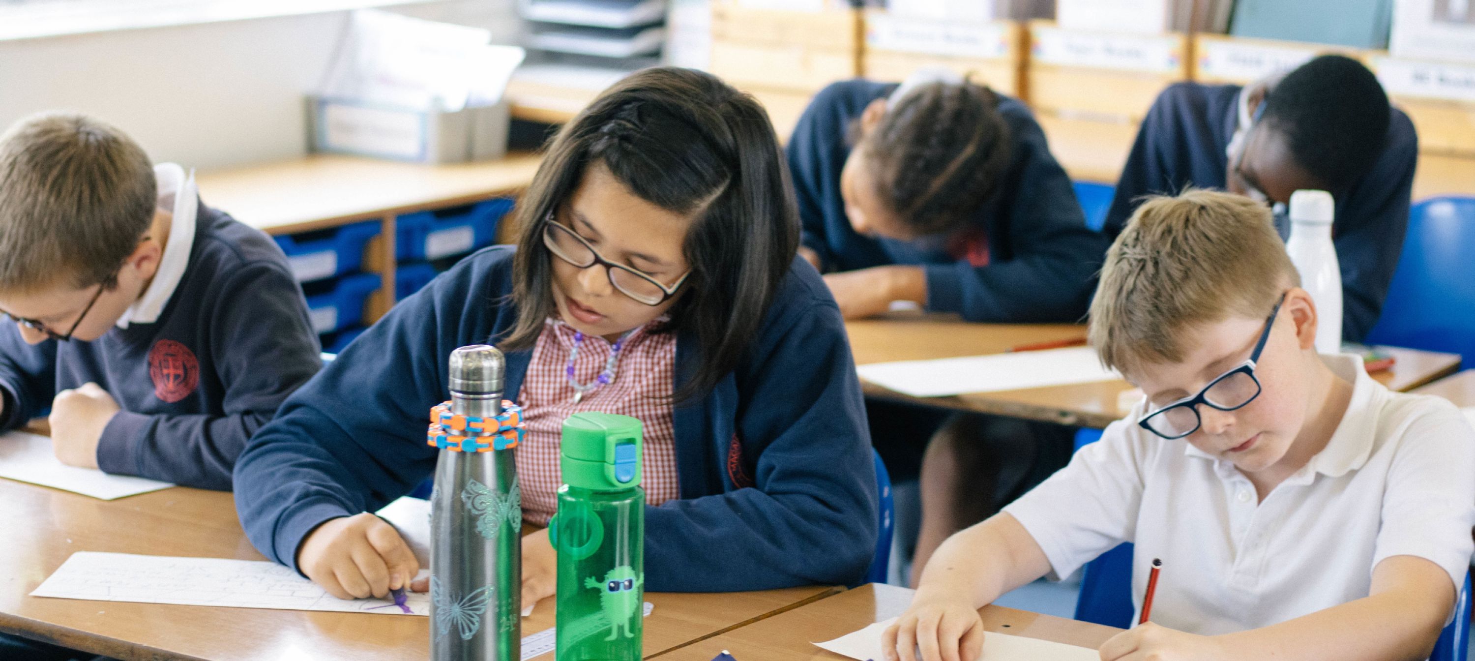 Pupils working at their desks in a classroom