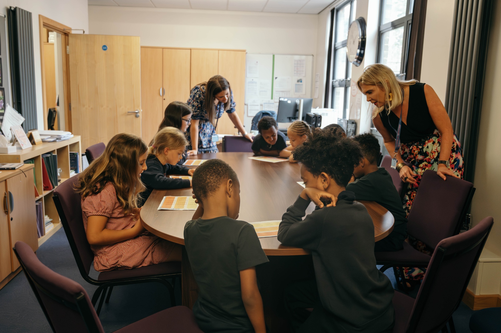 Pupils taking part in a School Council meeting around a table