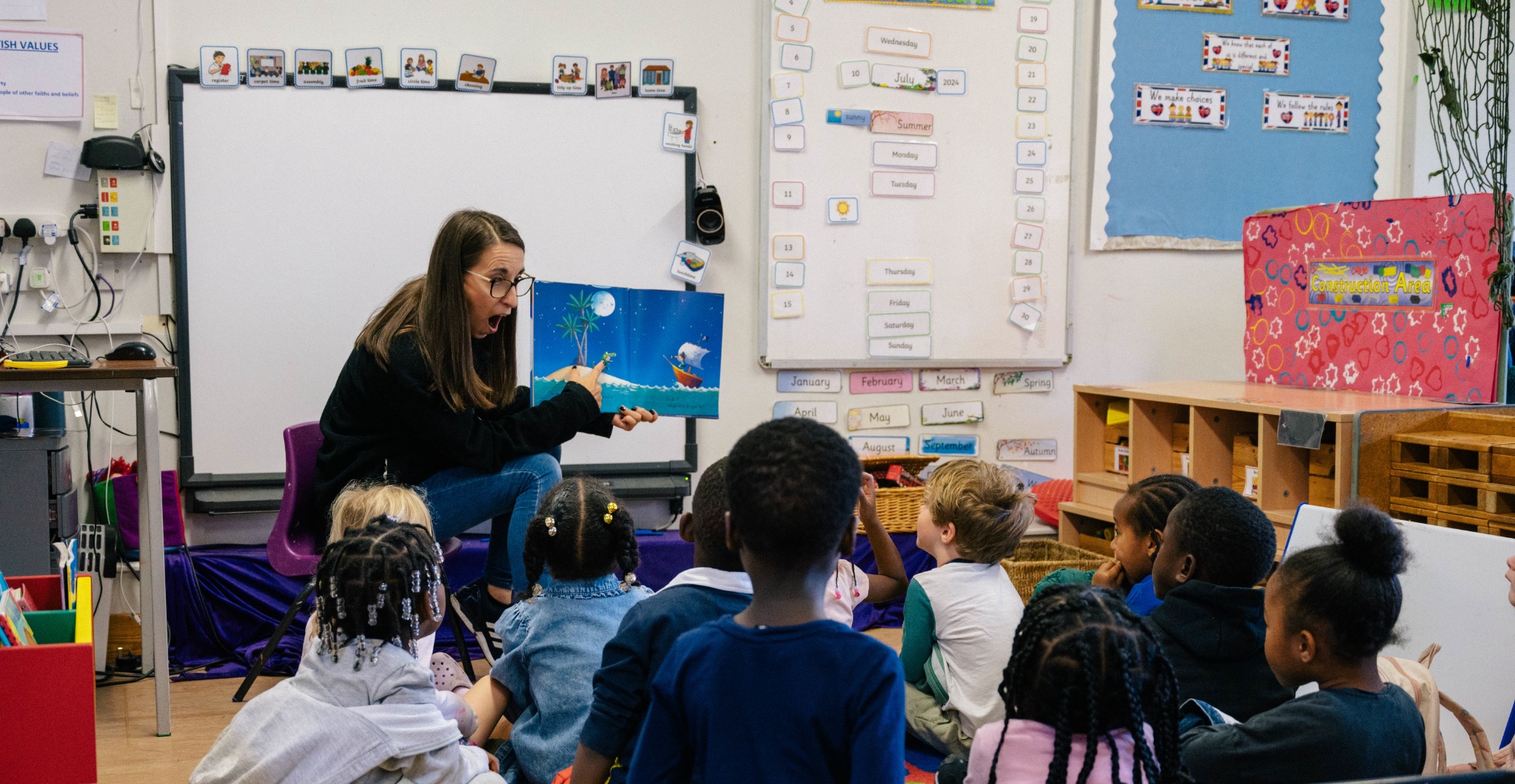 Teacher reading to a nursery class