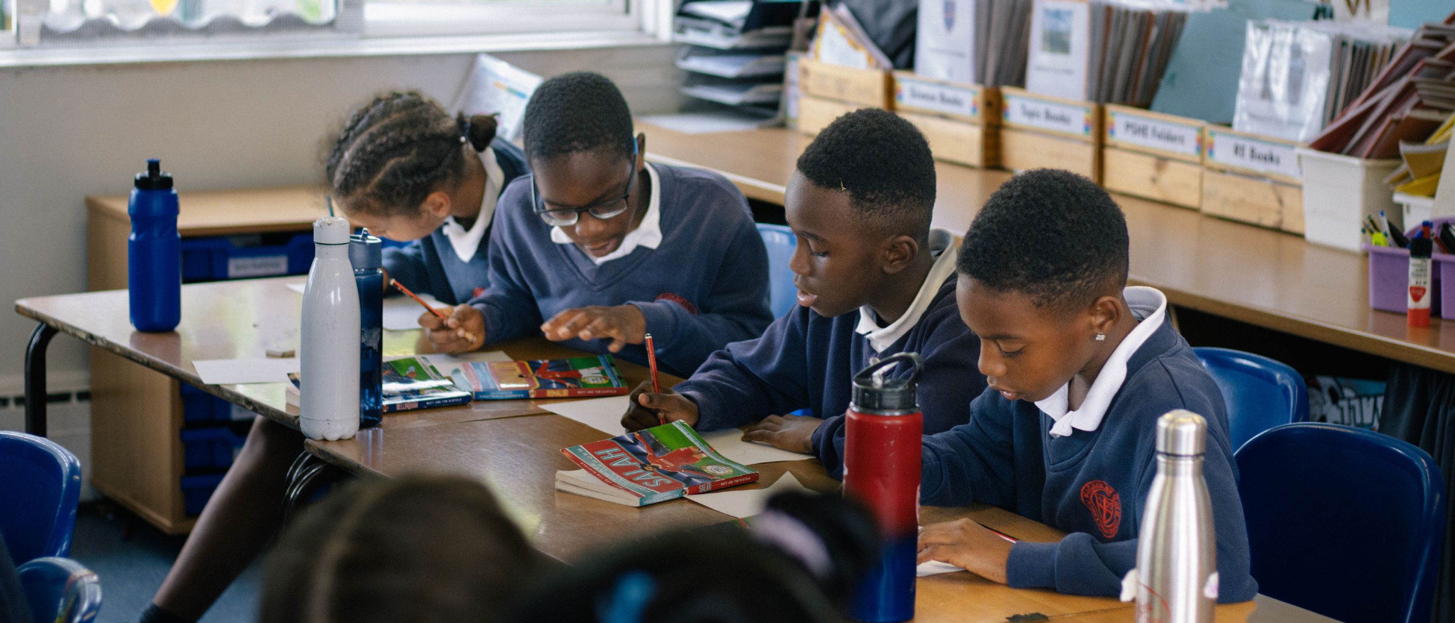 Pupils working at their desks in a classroom