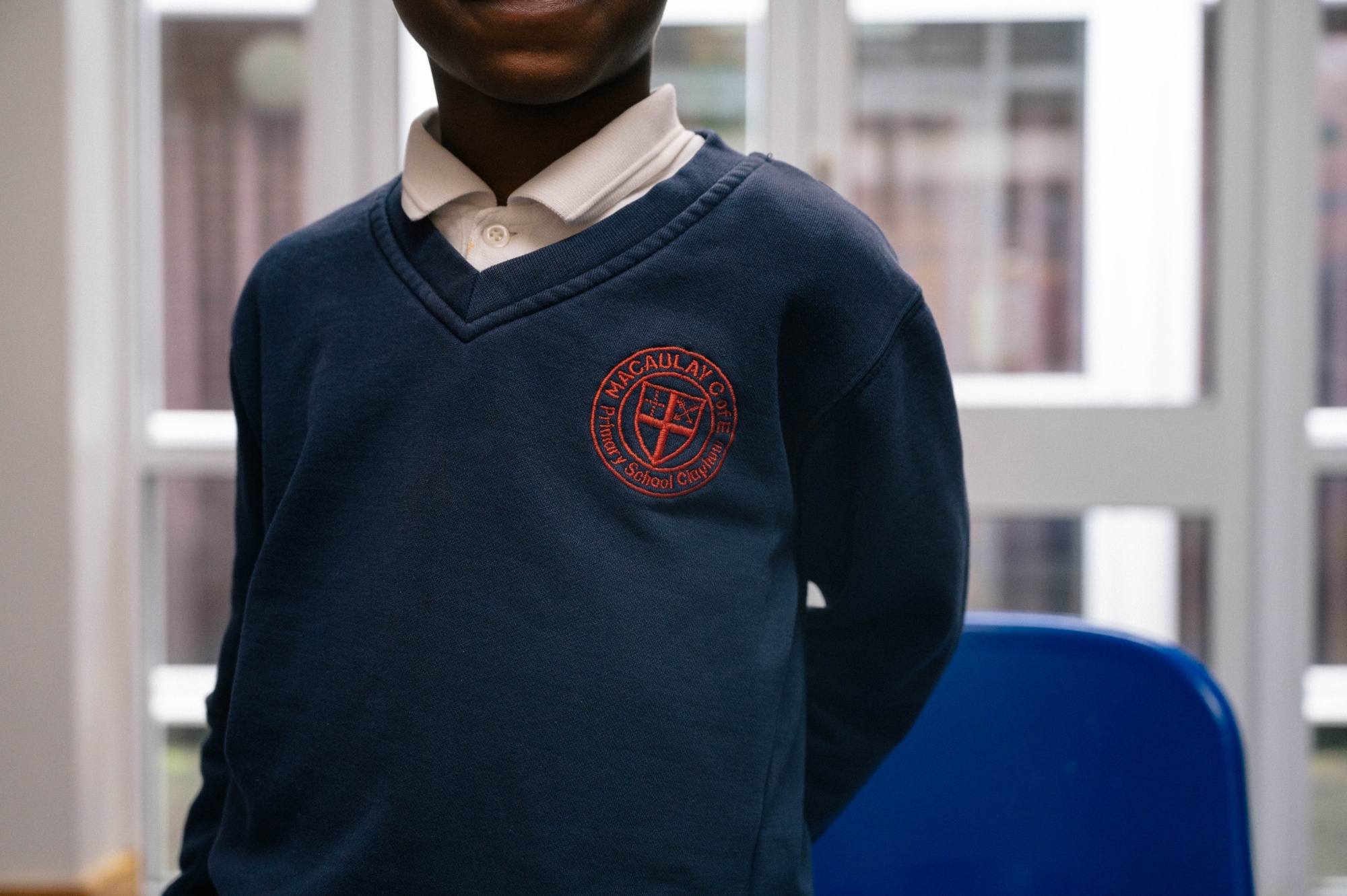 Navy jumper with red school logo