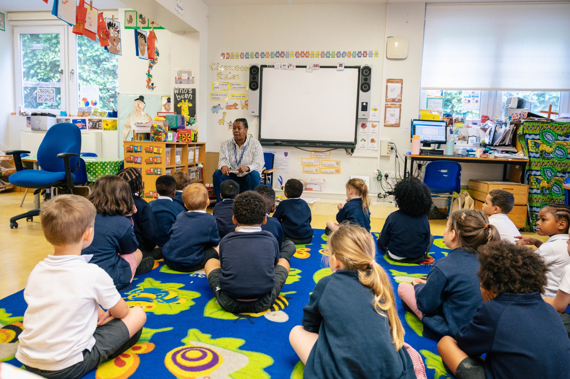 A teacher speaking to a reception class